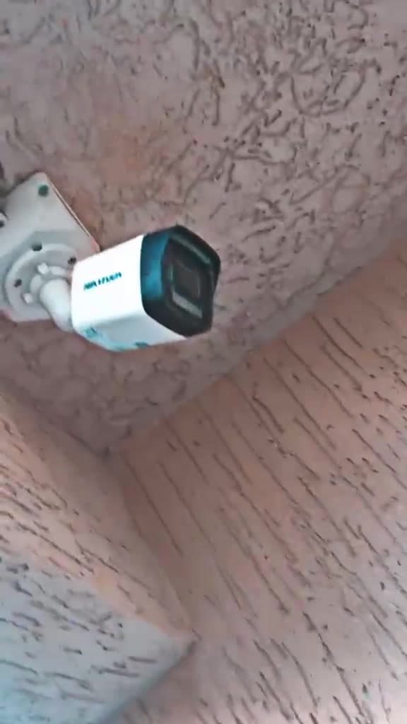 External bullet security cameras mounted under a roof eave by KENVO